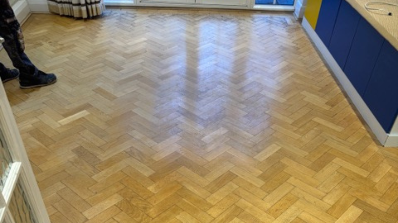 Parquet Floor Sanding in Finchley on an oak herringbone parquet kitchen-diner floor, showing a smooth, freshly refinished surface.